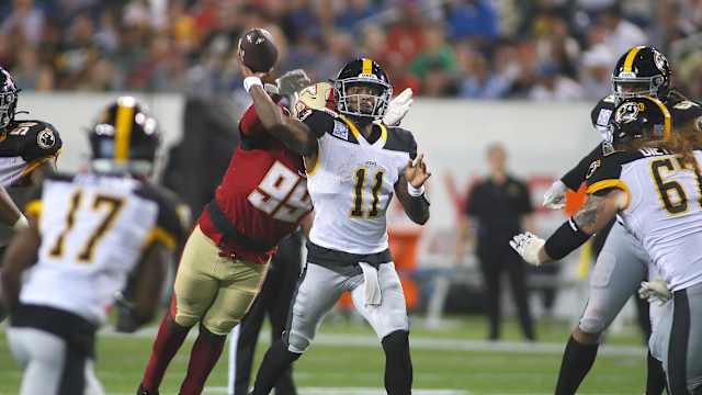 Pittsburgh Maulers Troy Willaims (11) throws downfield before being tackled by Birmingham Stallions Dondrea Tillman (99) during the second half of the USFL Championship game Saturday evening at Tom Benson Stadium in Canton, OH.